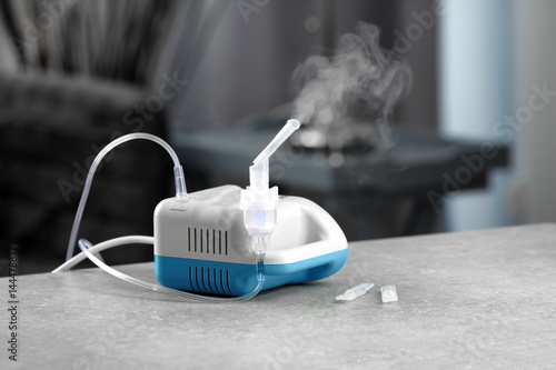Compressor nebulizer with mouthpiece on table