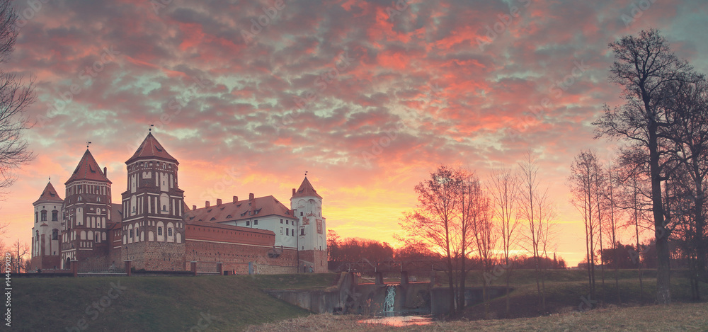 Landscape of the old castle against the background of dawn.
