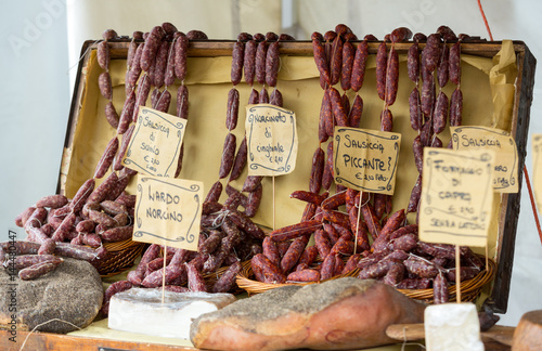 Italian different traditional sausages and ham at the store.
