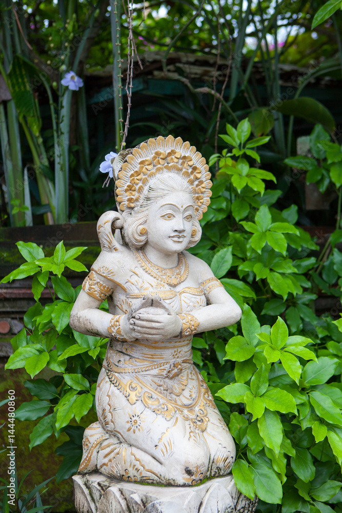 Girl statue in white stone in Balinese style