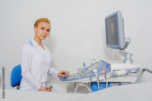 doctor working at ultrasound diagnostic machine