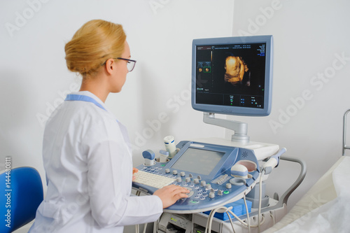 doctor analyze the result of ultrasound diagnostic machine photo