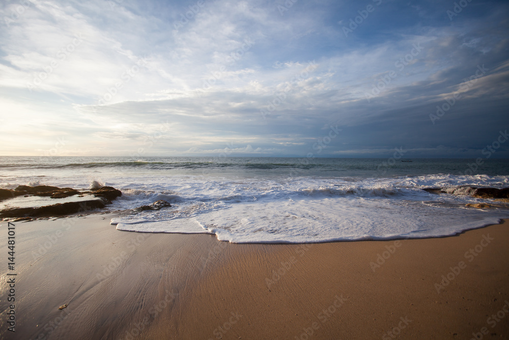 Ocean waves breaking on the rocks on the beach