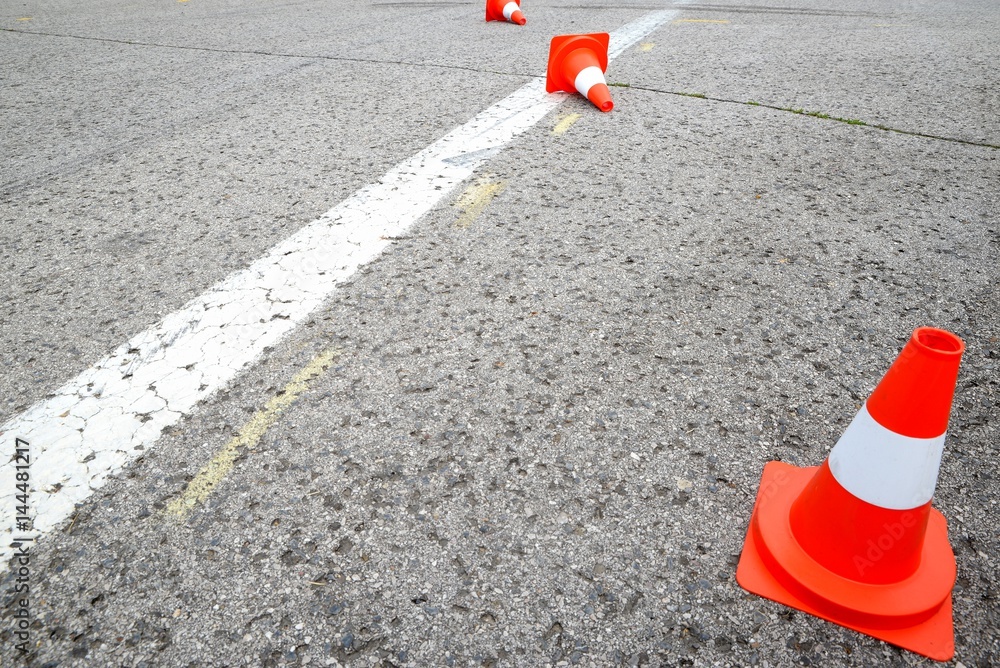 white line on the asphalt and posts warning