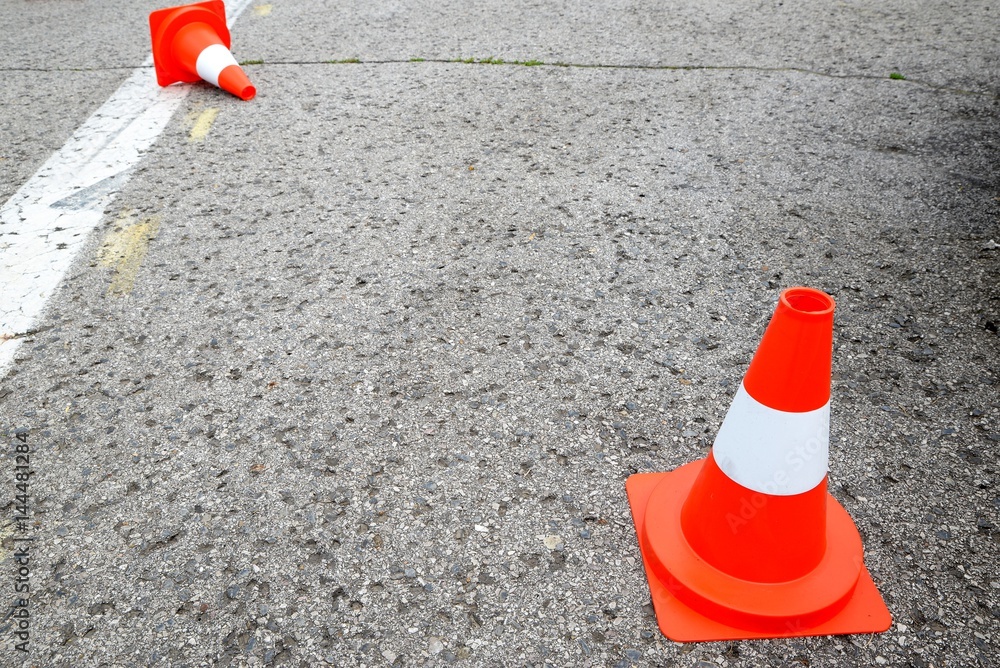 white line on the asphalt and posts warning