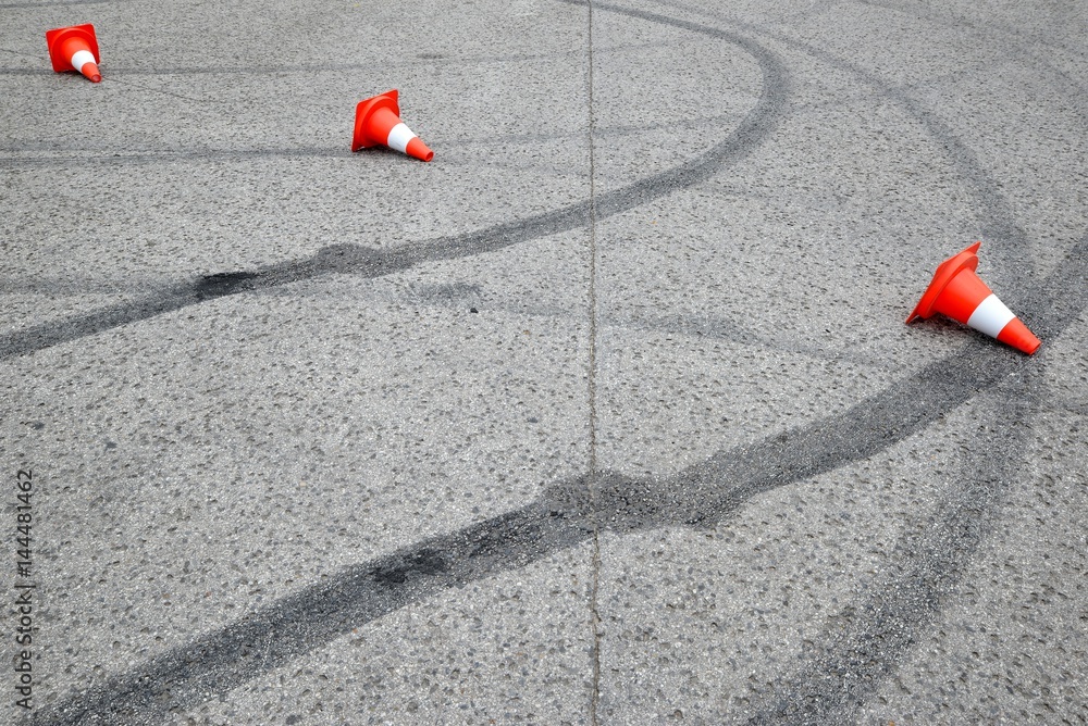 tire marks on the asphalt and posts a warning