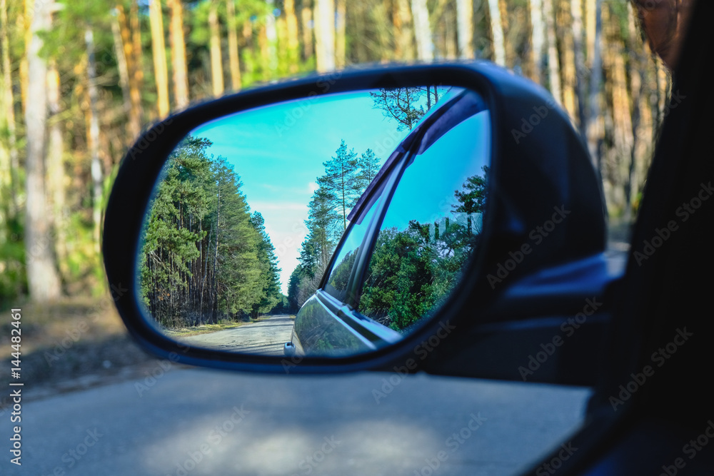 look in the rear view mirror of a car
