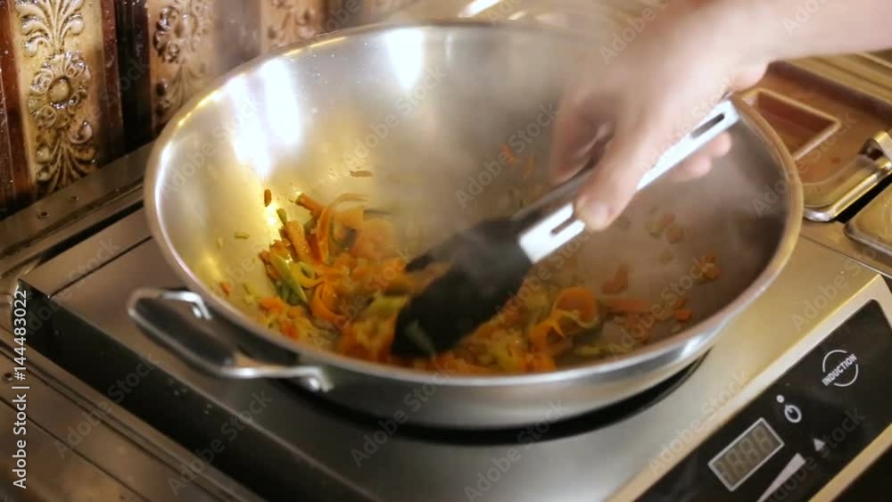 Chef Mixes vegetable Pasta in pan Chef Mixes vegetable Pasta in pan