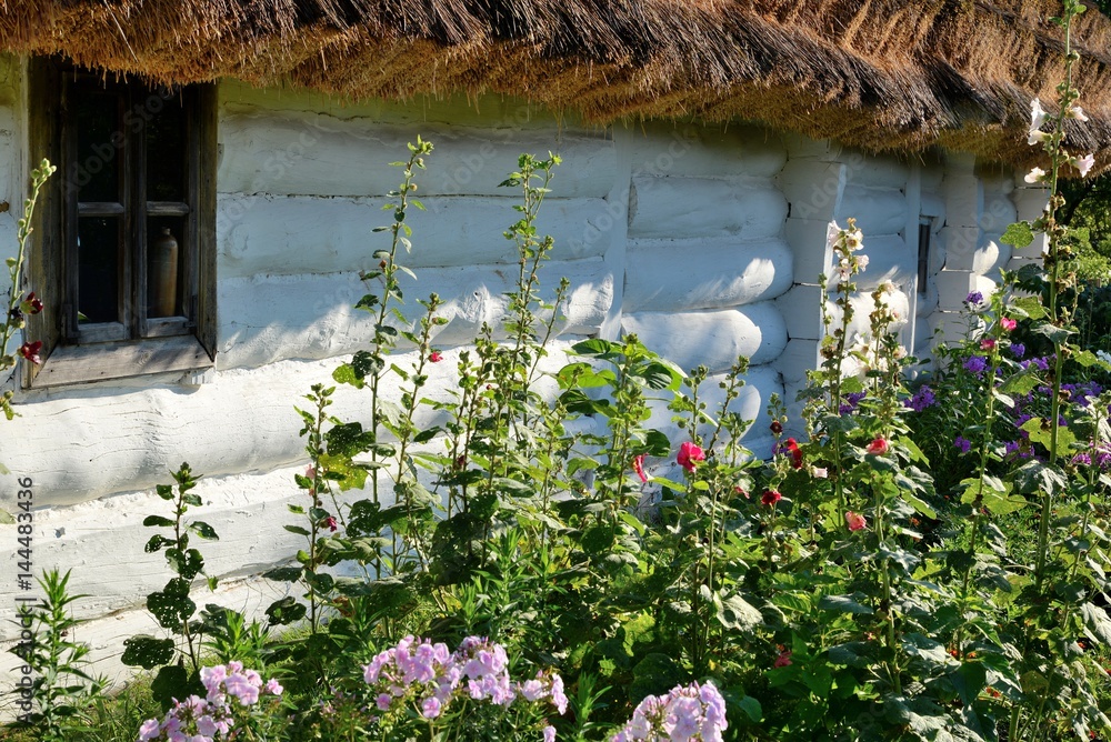 flowers on the old wooden hut covered with thatch village