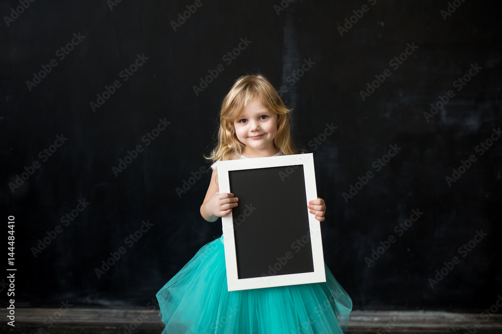 Cute little girl with a frame in her hands Cute little girl with a frame in her hands