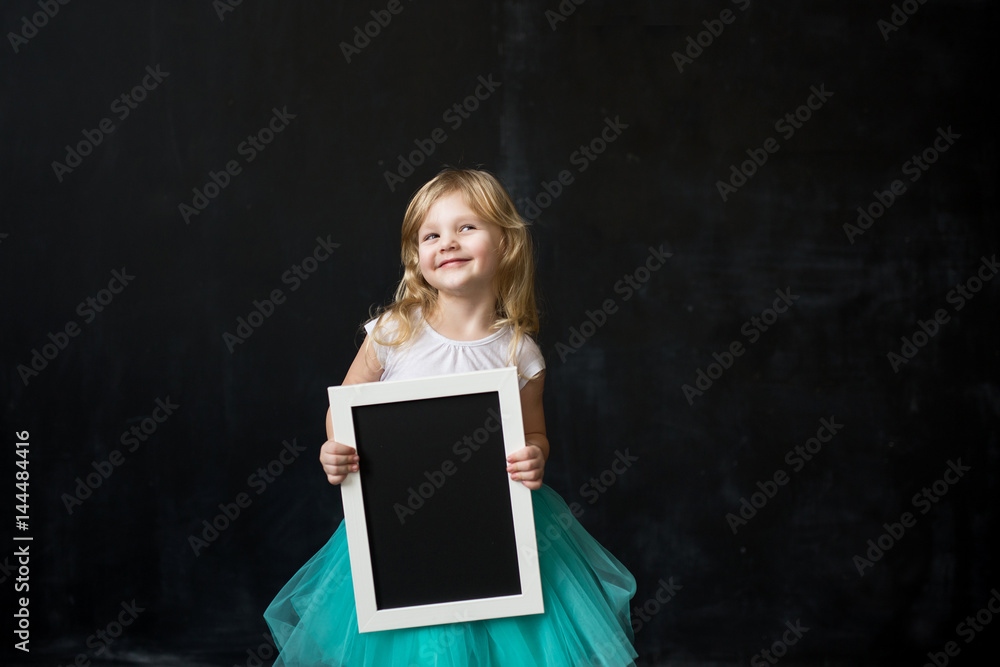girl holding empty blackboard with wooden frame girl holding empty blackboard with wooden frame