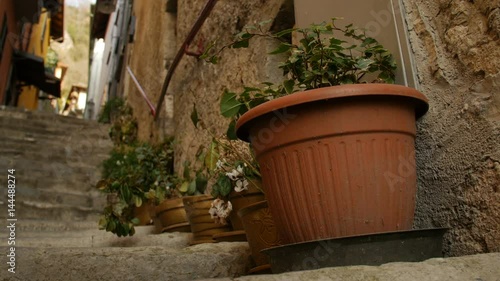 Decorative pots with flowers on the street of Italian town Varenna. photo