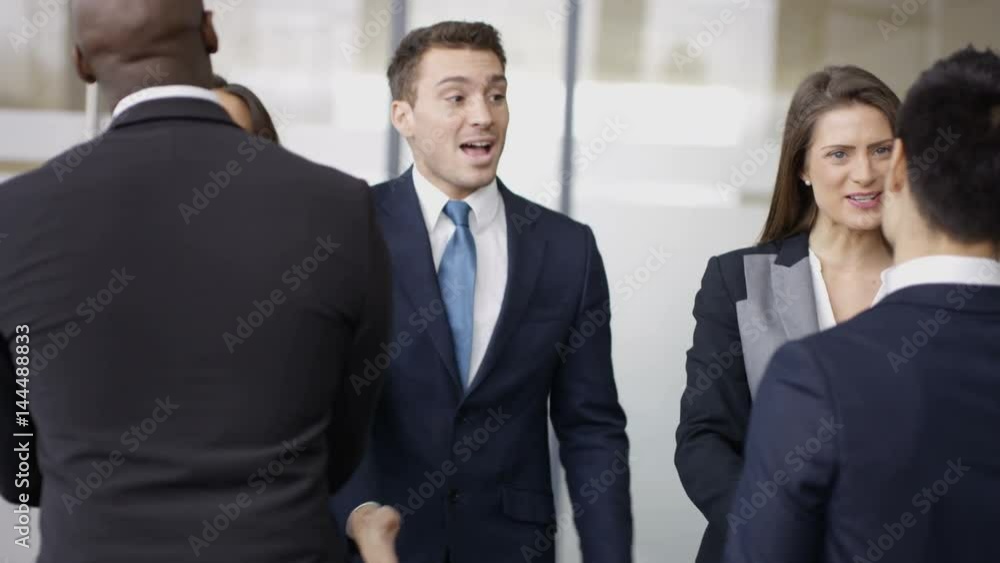 Business teams greet each other & shake hands in modern office building Business teams greet each other & shake hands in modern office building