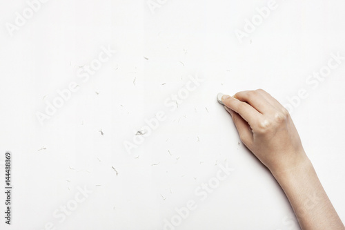 woman(female) hand hold a eraser isolated white. photo