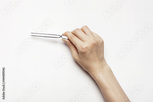 woman(female) hand hold a pincette isolated white. photo