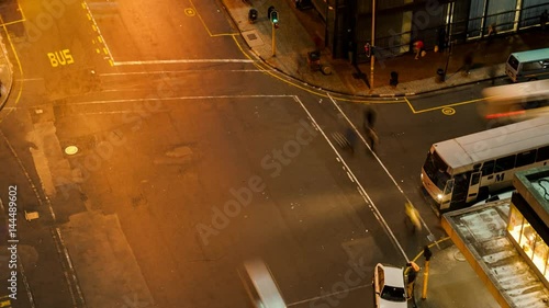 Timelapse panning up at a busy intersection at night shooting down with traffic and people crossing in Ghandi Square, mid city Johannesburg, South Africa photo