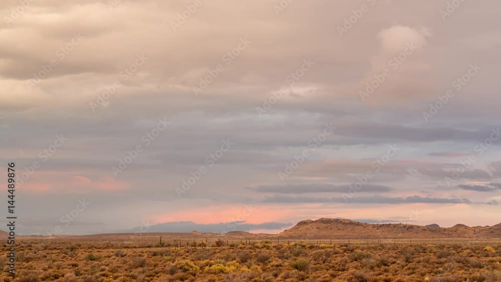 A beautiful static timelapse of a typical Karoo farm landscape in soft warm magenta light with various cloud movements, typical of an old artist painting A beautiful static timelapse of a typical Karoo farm landscape in soft warm magenta light with various cloud movements, typical of an old artist painting