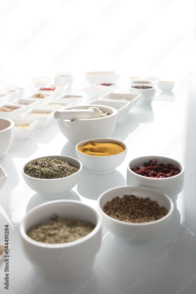leguminous vegetables and spices in bowls, isolated on a white background leguminous vegetables and spices in bowls, isolated on a white background