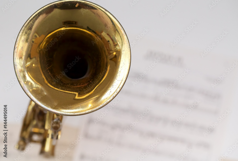 Naklejka premium Trombone with Sheet Music in Background