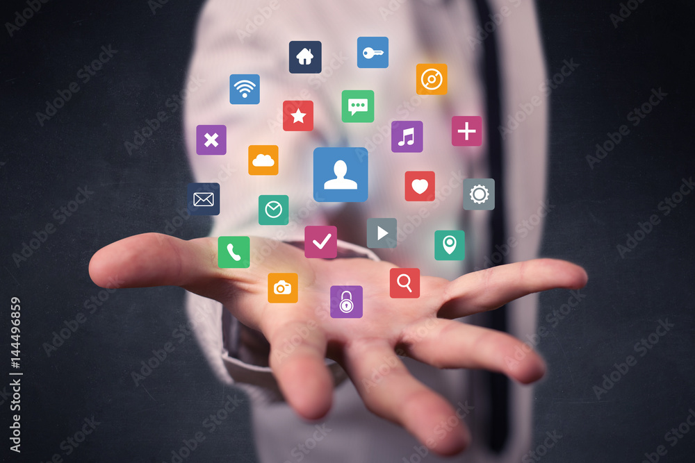 Businessman holding colorful applications Businessman holding colorful applications