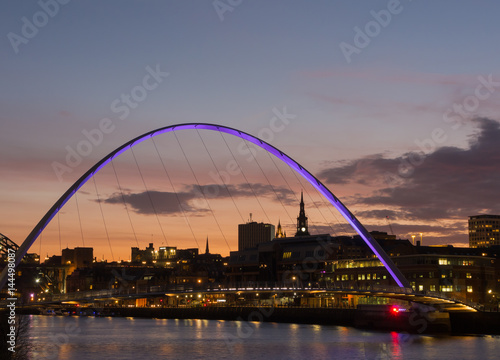 Newcastle upon Tyne, England, United Kingdom. The Gateshead Millennium Bridge and its colors during evening time