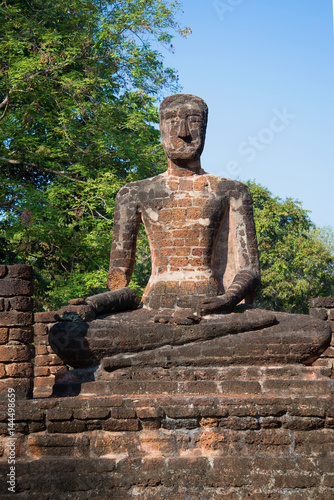 Ancient sculpture of a seated Buddha on the ruins of the Buddhist temple  Wat Singha. Kamphaeng Phet  Thailand