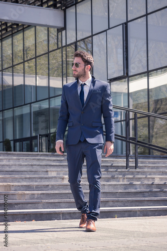 one young man, walking suit tie