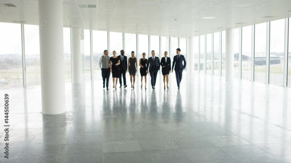 Portrait happy multiracial business team in large open plan office Portrait happy multiracial business team in large open plan office