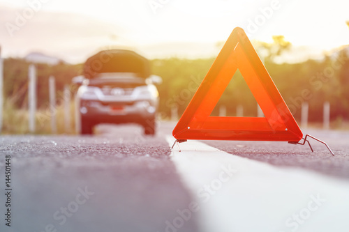 Картината върху платно Red emergency stop sign and broken silver car on the road
