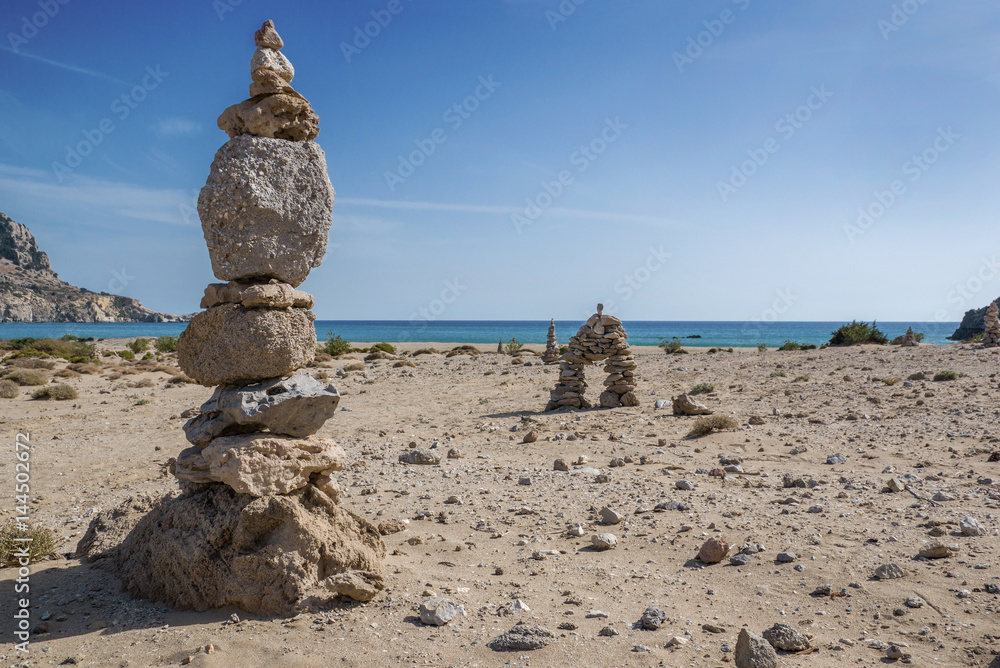 Stone pyramids on Tsambika beach. Tsambika (or Tsampika) is one of the most beautiful beaches on Rhodes, Greece