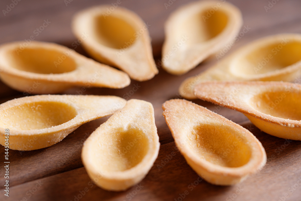 Photography of a empty tartlets on a wooden background 