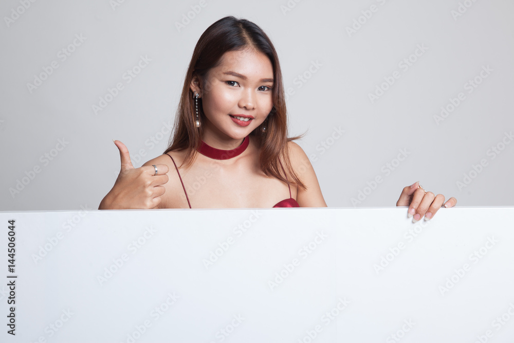 Young Asian woman show thumbs up with blank sign. Young Asian woman show thumbs up with blank sign.