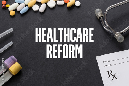 HEALTHCARE REFORM written on black background with medication photo