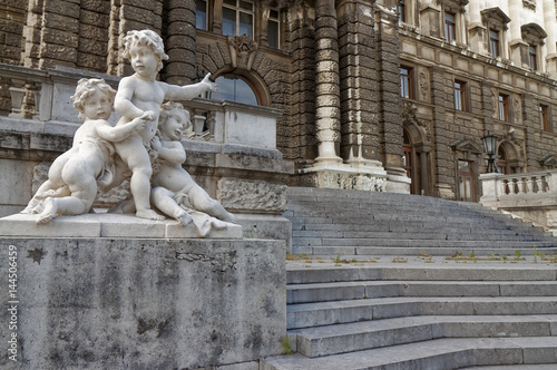 Sculpture of playful children against the background of stone  antique stairs.