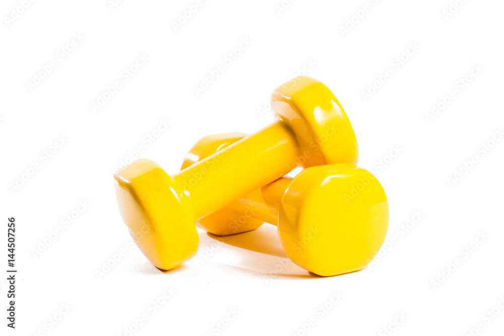 Two yellow dumbbells on an isolated background In a random order Two yellow dumbbells on an isolated background In a random order