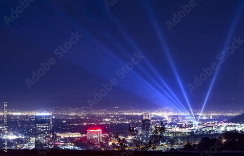 Принти на полотні Huge spotlight rays over the night panorama of Los Angeles city