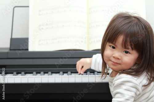 Japanese girl playing a piano (2 years old)