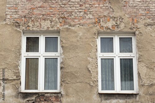 Six windows on the facade of the ragged old house