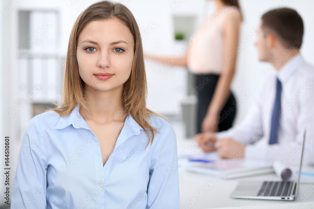 Portrait of a young business woman at meeting. Portrait of a young business woman at meeting.