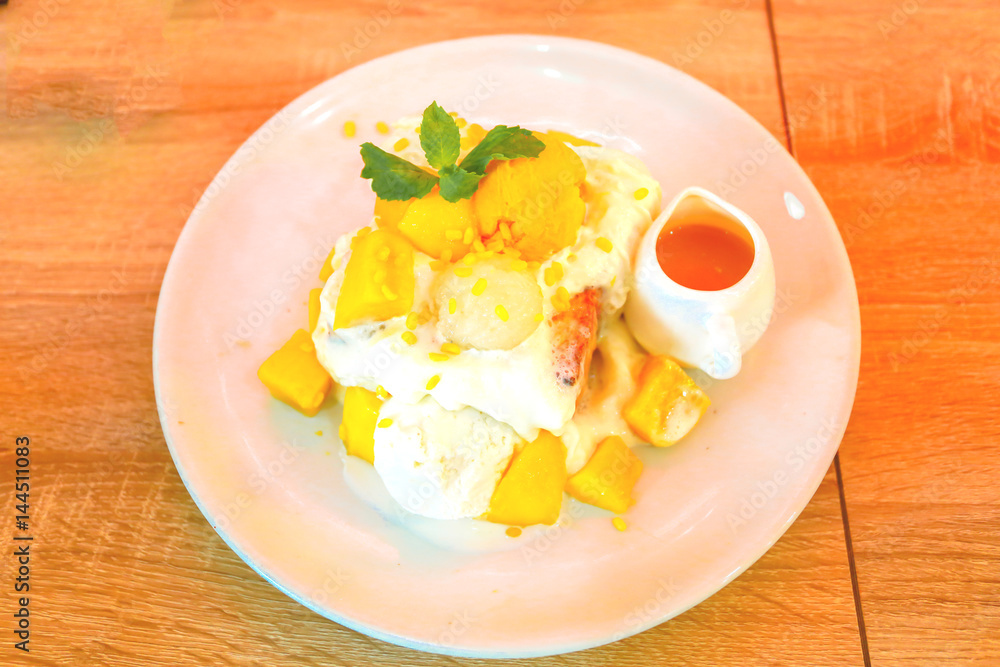 Bingsu ( Korea food) with mango on table Bingsu ( Korea food) with mango on table