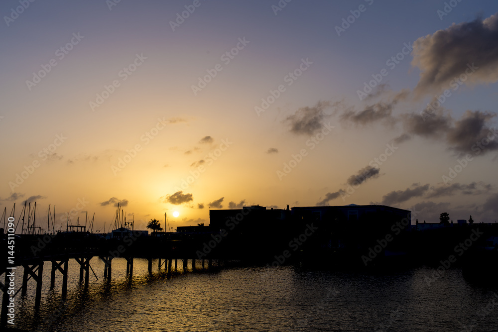 Dark sunset colourful sky on a harbour pier bridge