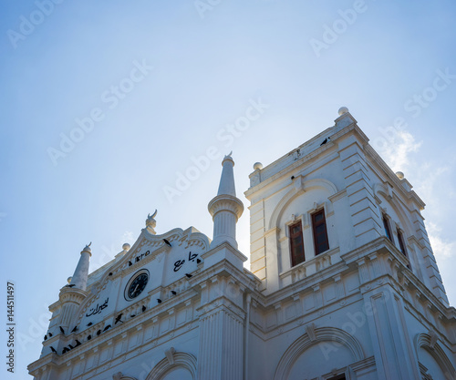 Facade of the Meeran Jumma Masjid Mosque against blue sky. photo