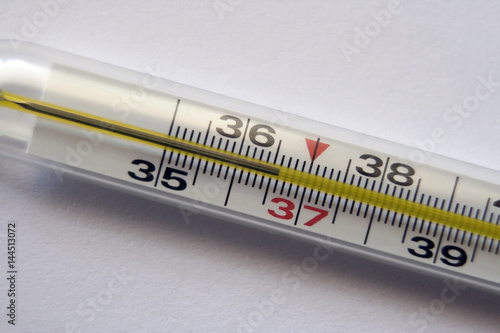 Thermometer with a reading of the normal temperature of the human body: 36.6 degrees Celsius. Close-up on a white background