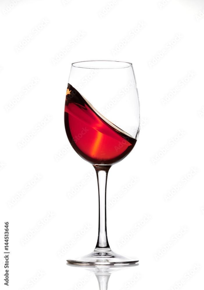 Classic Glass of Red Wine isolated on a white background. Splashing red wine in a glass. A splash of red wine in a glass. Grapes. Alcohol. Classic Glass of Red Wine isolated on a white background. Splashing red wine in a glass. A splash of red wine in a glass. Grapes. Alcohol.