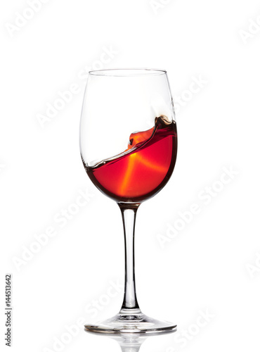 Classic Glass of Red Wine isolated on a white background. Splashing red wine in a glass. A splash of red wine in a glass. Grapes. Alcohol.