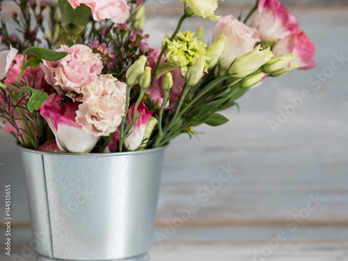Spring flowers in small tin bucket