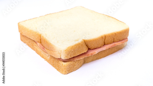 Quadro su tela sliced white bread with ham sandwich on white background