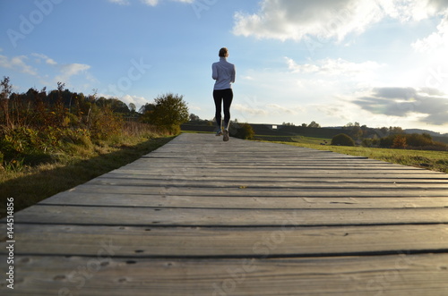 girl running on the wooden pavement