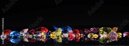 Colorful of different gemstones with space for text on black background.