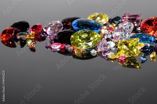 Colorful of different gemstones with space for text on dark background.